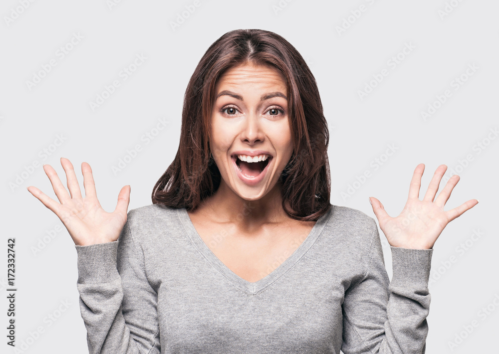 Young beautiful surprised girl portrait isolated on gray Young beautiful surprised girl portrait isolated on gray