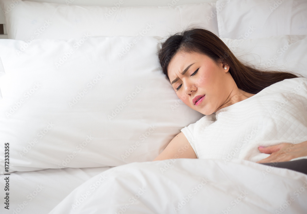 Asian woman stomachache, feel pain for period concept Asian woman stomachache, feel pain for period concept