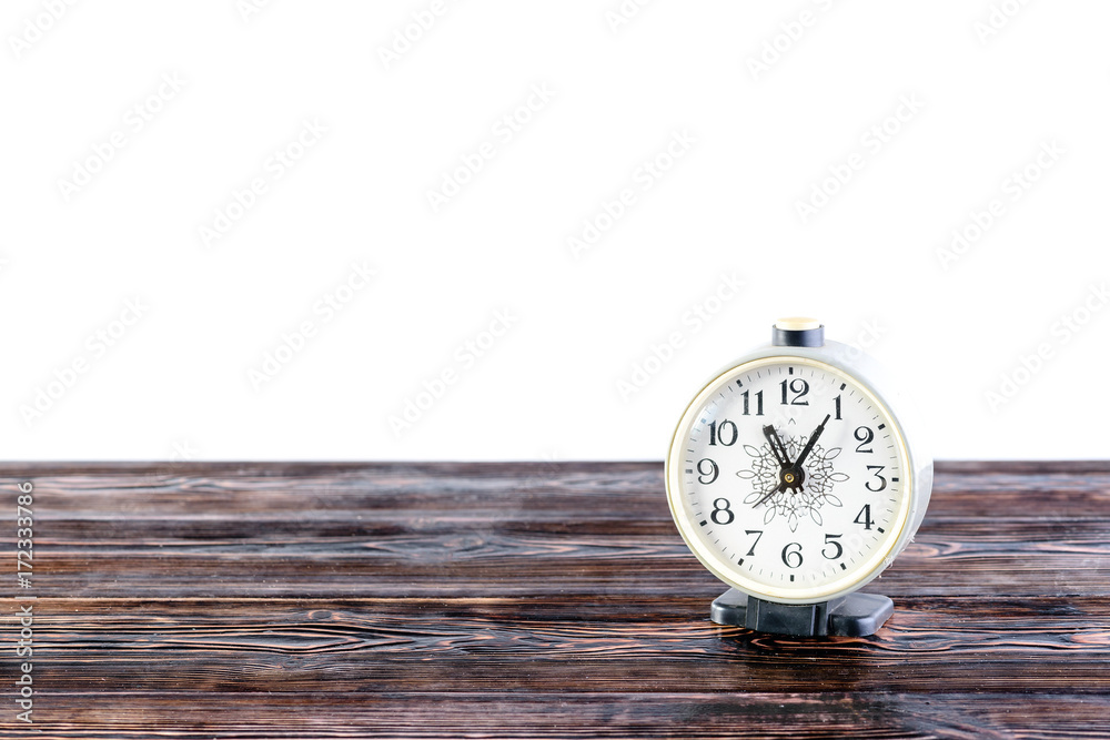 Wooden table top with desk clock isolated on white background Wooden table top with desk clock isolated on white background