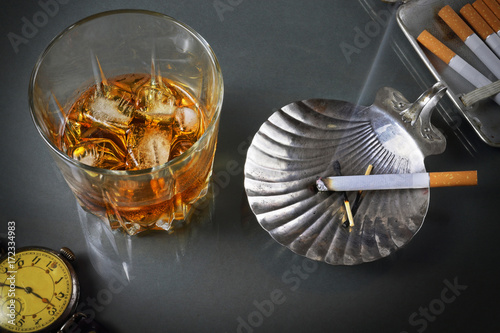Still life with a whisky glass and cigarettes in a retro style