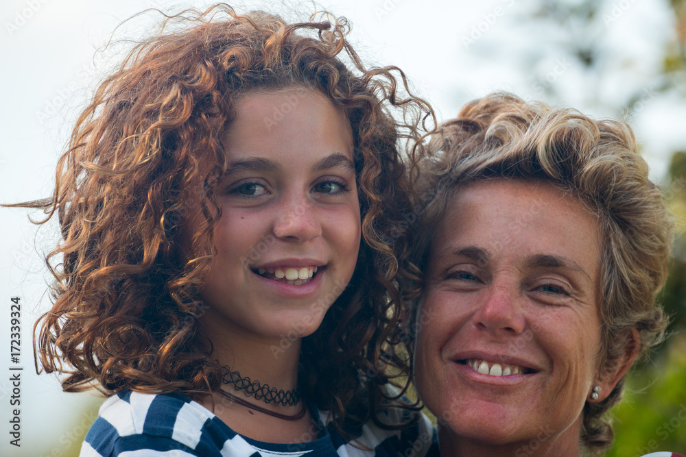 Fototapeta premium A mother with her daughter in a very affectionate and happy attitude...