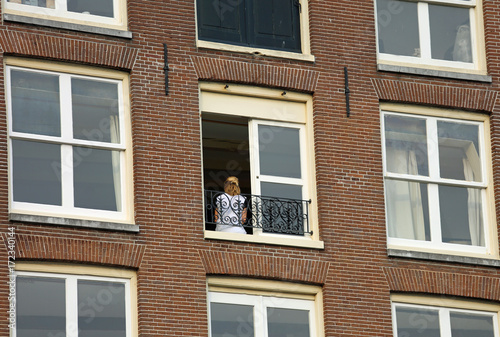 blonde girl at the apartment building window © ChiccoDodiFC