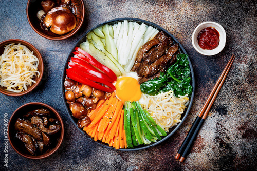 Bibimbap, traditional Korean dish, rice with vegetables and beef. Top view, overhead, flat lay