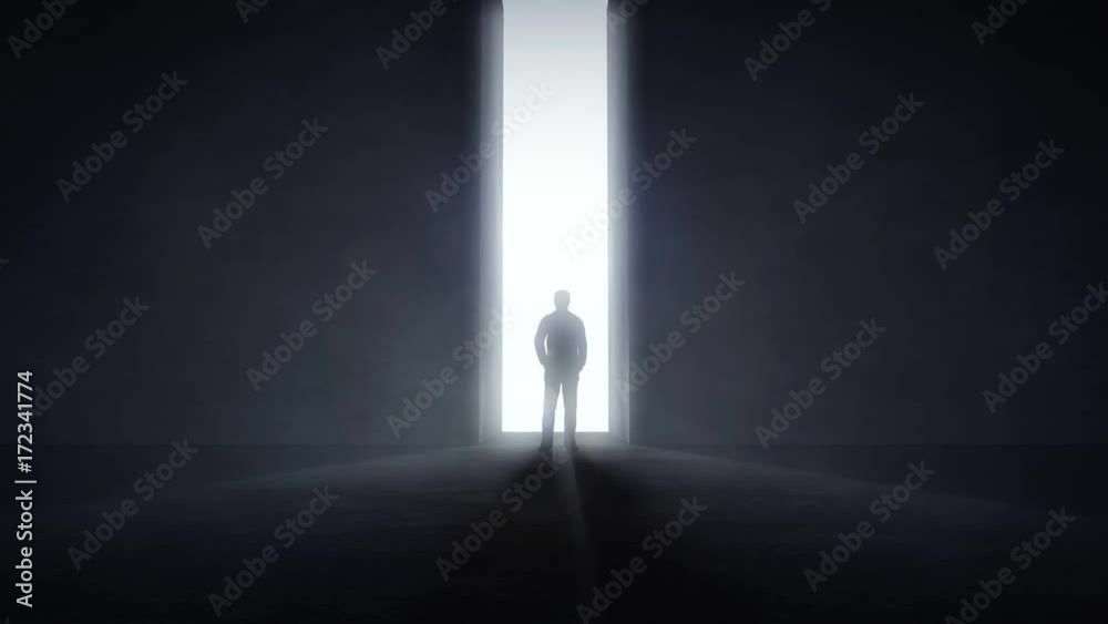 Man standing in the front of an opening wall with light coming trough Man standing in the front of an opening wall with light coming trough