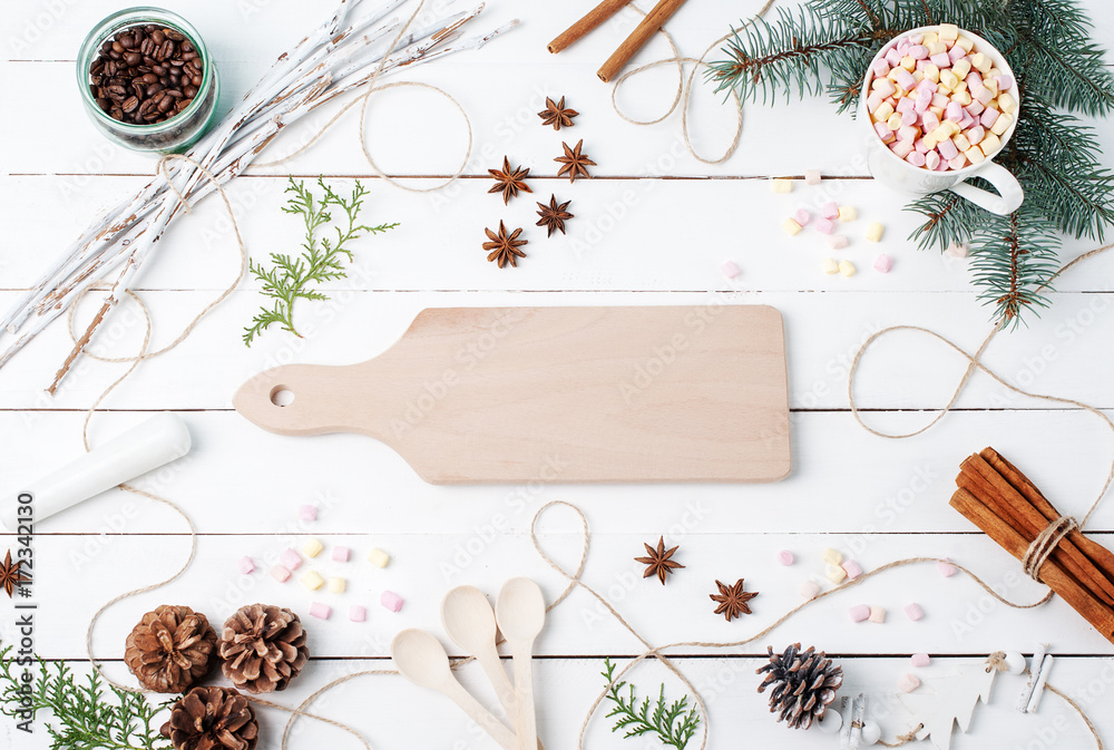 Winter or autumn composition. Hot chocolate with marshmallow, cinnamon sticks, anise star, spoons, coffee seeds, fir, pine cones and wooden desk for copy space. Christmas concept. Flat lay, top view Winter or autumn composition. Hot chocolate with marshmallow, cinnamon sticks, anise star, spoons, coffee seeds, fir, pine cones and wooden desk for copy space. Christmas concept. Flat lay, top view