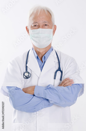 Old Asian medical doctor in face mask