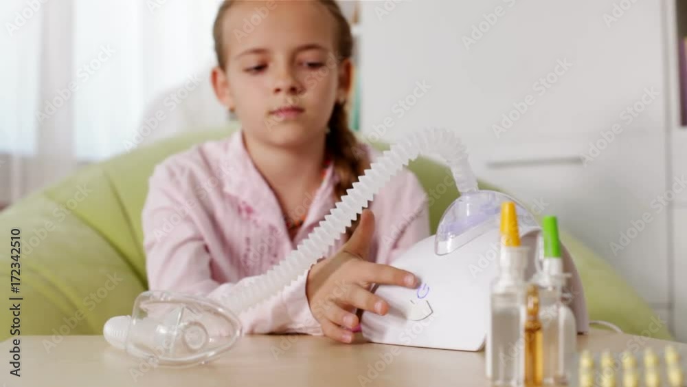Young girl using nebuliser inhaler with mask - rack focus, static camera Young girl using nebuliser inhaler with mask - rack focus, static camera