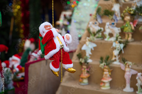 Santa Claus toy on a Christmas market. Traditional Xmas New Year home decor decoration for holiday season.