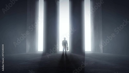 Businessman standing at opening glowing light tunnels in front of a high concrete wall, decision concept