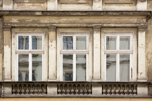 Three ragged Windows on the facade of the old house