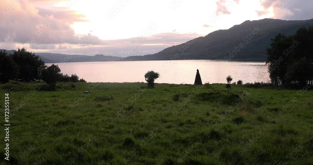 4K Scottish loch surrounded by rolling hills, green grass, as clouds roll across the sky 4K Scottish loch surrounded by rolling hills, green grass, as clouds roll across the sky