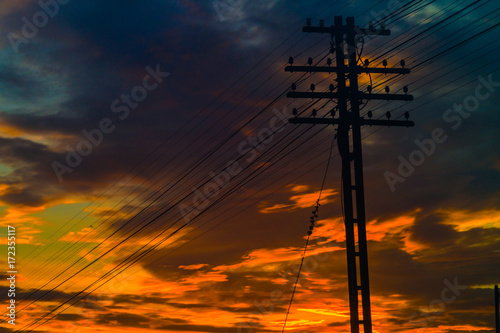 Electricity station. Close up high voltage power lines at sunset.