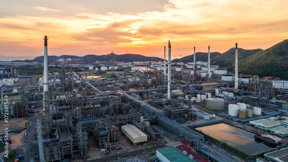 Obraz premium Aerial view Oil refinery.Industrial view at oil refinery plant form industry zone with sunrise and cloudy sky.Oil refinery and Petrochemical plant at dusk,Thailand.