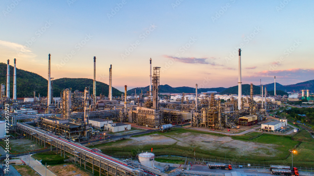 Obraz premium Aerial view Oil refinery.Industrial view at oil refinery plant form industry zone with sunrise and cloudy sky.Oil refinery and Petrochemical plant at dusk,Thailand. Oil refinery background sunset.