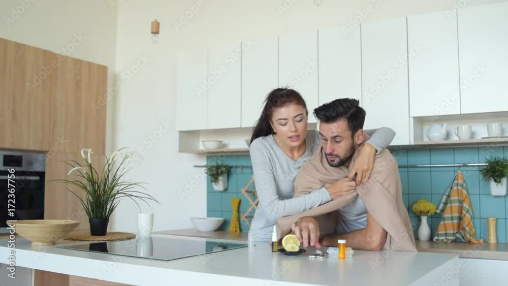 Smiling young lady looking after ill millennial guy