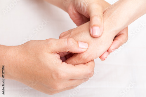 Woman receiving osteopathic treatment of her thumb