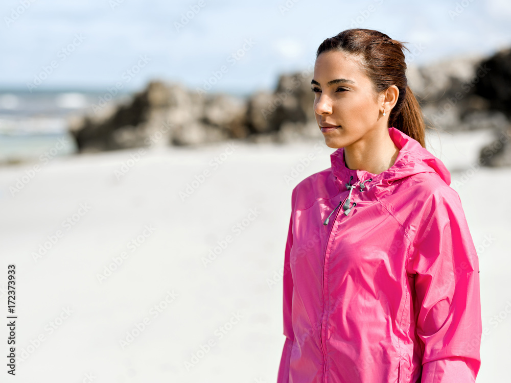 Athletic woman in sportswear standing at the seaside Athletic woman in sportswear standing at the seaside