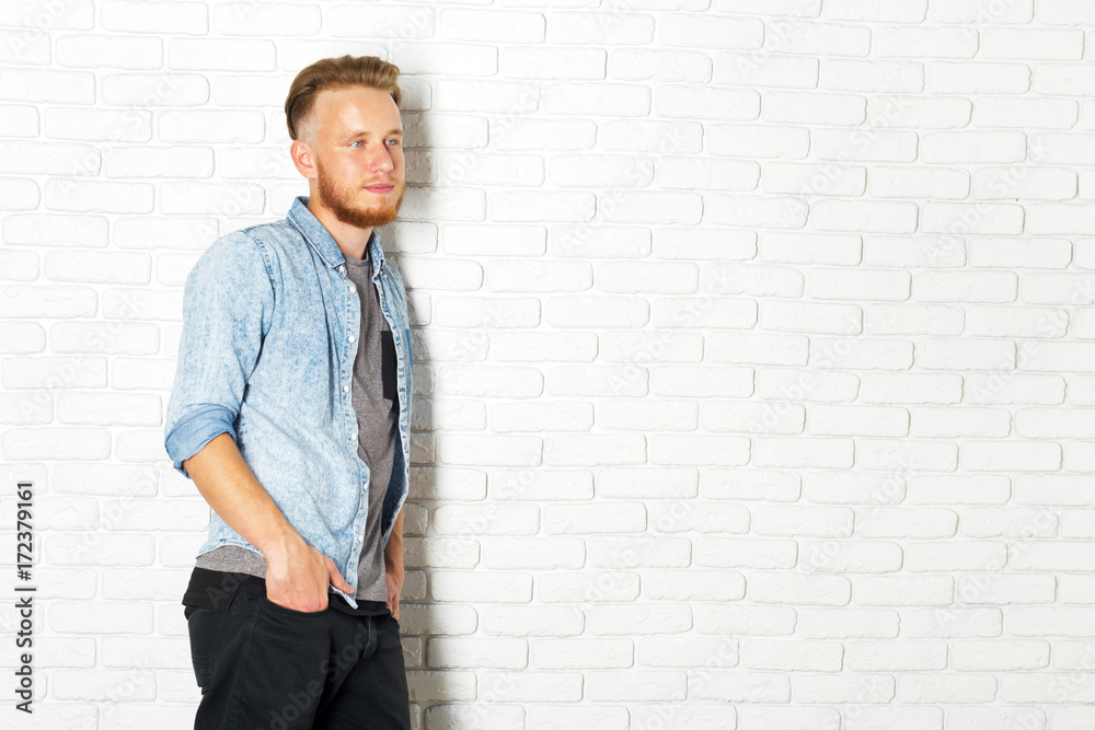 Young Sexy Man Against a White Brick Wall Young Sexy Man Against a White Brick Wall