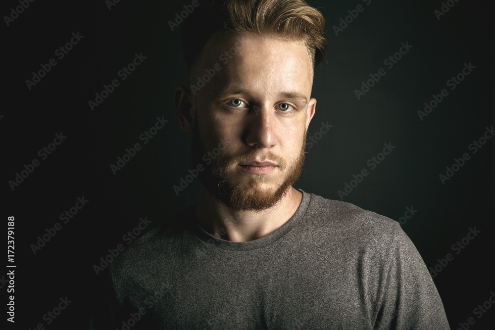 Fototapeta premium portrait of young man above black background
