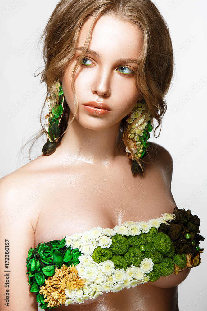 Beautiful woman portrait with flowers on body and earrings made from flowers. Beautiful woman portrait with flowers on body and earrings made from flowers.