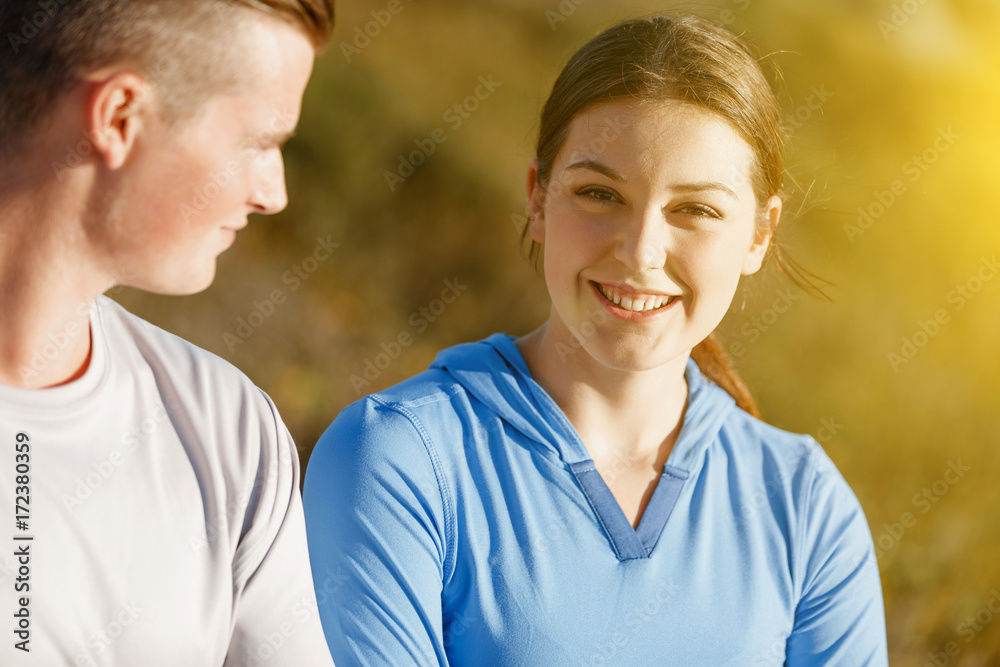 Young couple on beach in sportwear Young couple on beach in sportwear