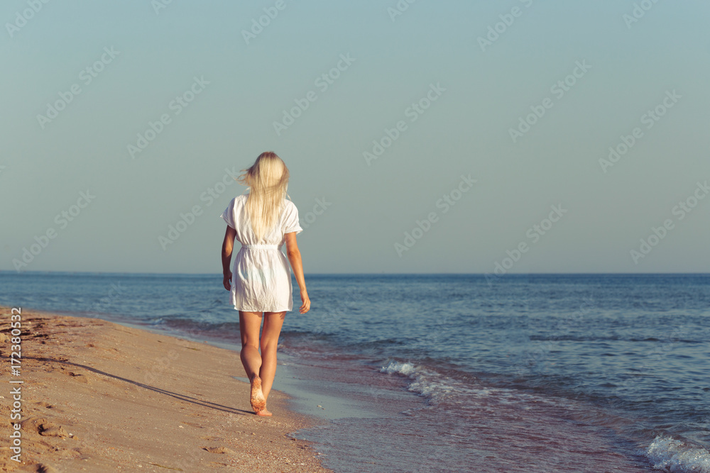 Young woman relaxing on the beach Young woman relaxing on the beach