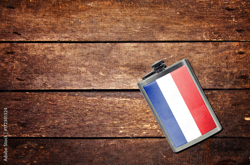Alcohol flask on the table with flag Alcohol flask on the table with flag