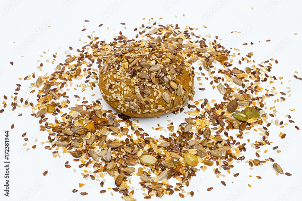 Rye bun seeded on a white background, macro Rye bun seeded on a white background, macro