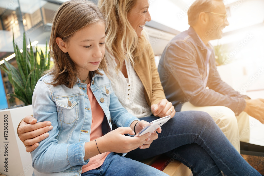 Family on shopping day in mall, sitting on public bench Family on shopping day in mall, sitting on public bench