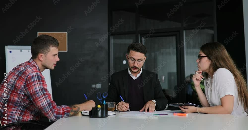 Creative team of a business meeting in a modern starting office, discussing ideas for the development of their business Creative team of a business meeting in a modern starting office, discussing ideas for the development of their business