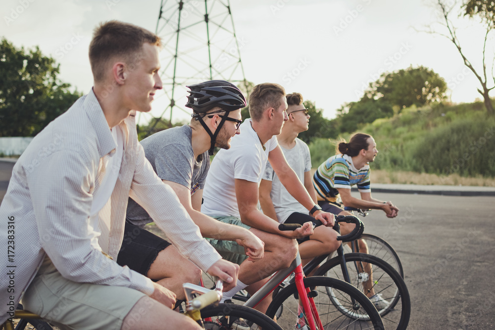 Group of cyclists starting riding fixed gear bikes on the road Group of cyclists starting riding fixed gear bikes on the road