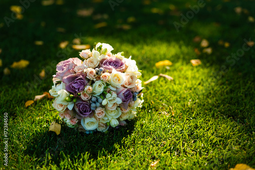 wedding flowers, wedding bouquet, bouquet of red and peach, dairy roses and white flowers lying on yellow autumn leaves, wedding ceremony, come autumn, time of year, the grass photo