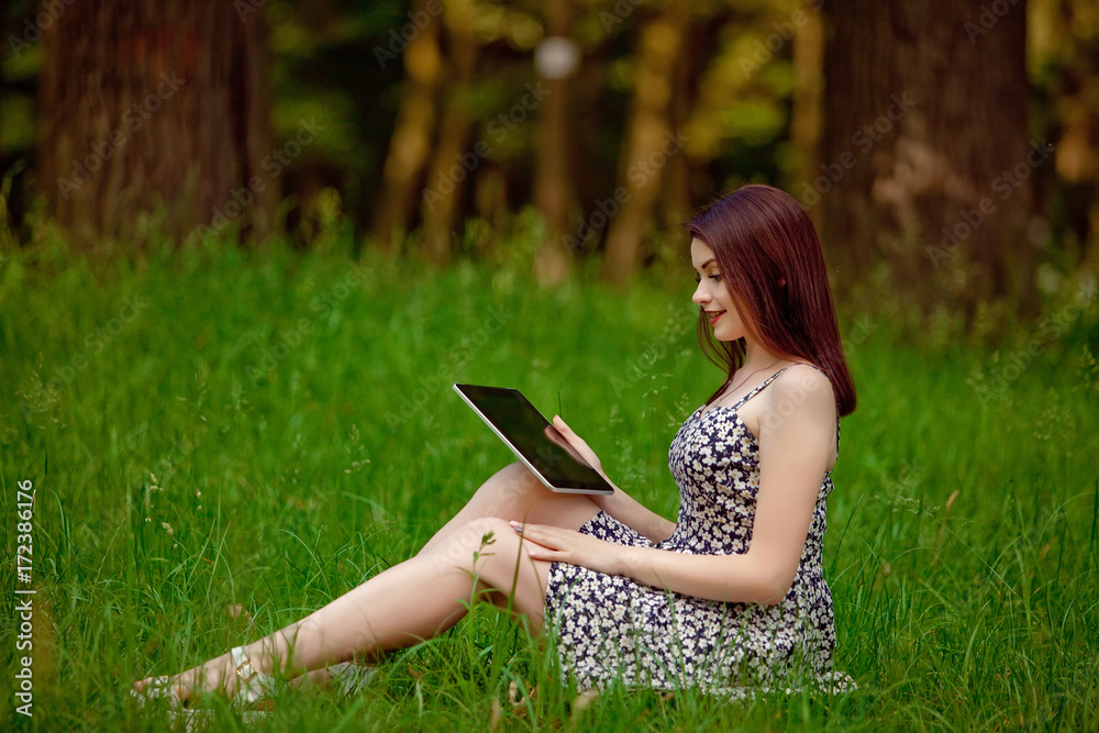 Brunette woman talking in a video call on line on nature Brunette woman talking in a video call on line on nature
