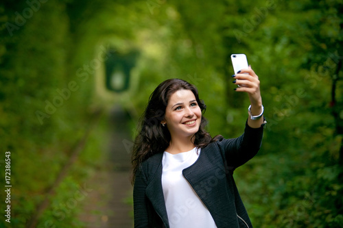 Beautiful woman Selfie Pictures in Natural tunnel of love formed by trees.