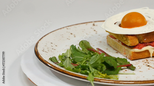 Sponge cake with strawberries, jam and whipped cream with a cut out piece photo