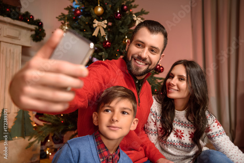 family taking selfie at christmas