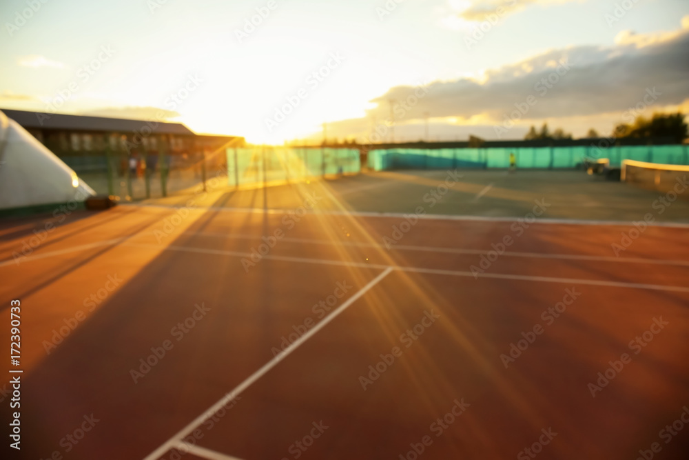 Fototapeta premium Tennis court at sunset, blurred view