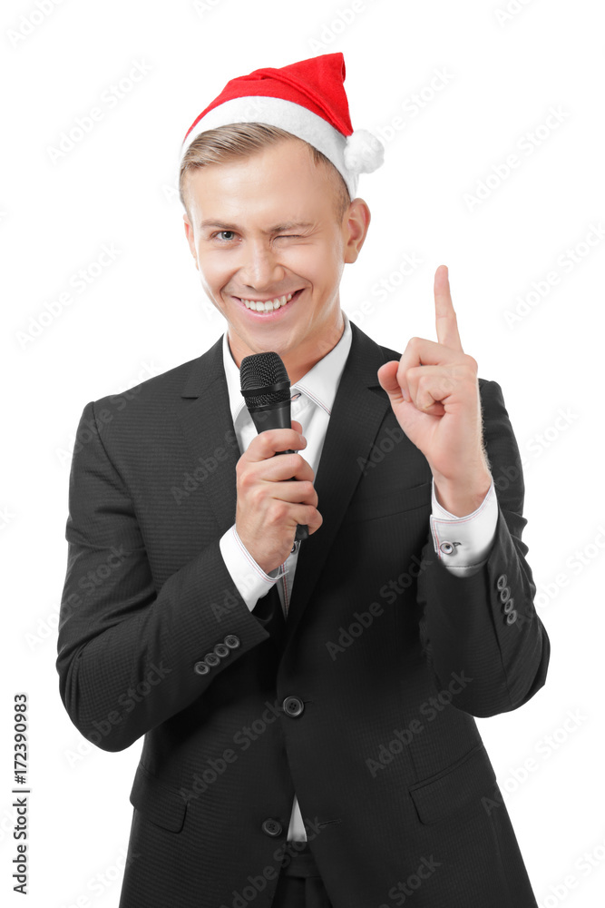 Young presenter in Santa hat with microphone on white background Young presenter in Santa hat with microphone on white background