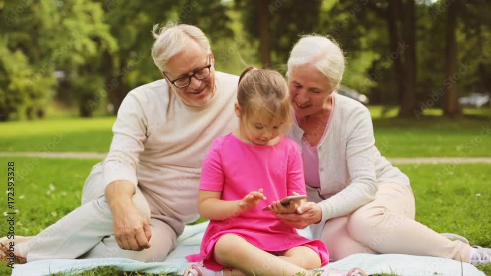 grandparents and granddaughter with smartphone grandparents and granddaughter with smartphone