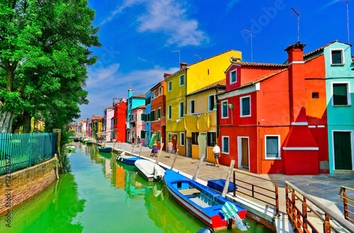 View of the colorful Venetian houses along the canal at the Islands of Burano in Venice. © Javen
