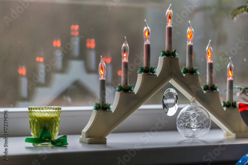 New Year's electric candles on the background of Christmas decorations