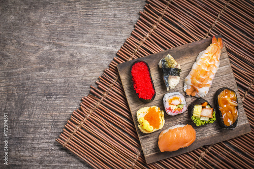 Sushi Set sashimi and sushi rolls served on wood slate,Top view