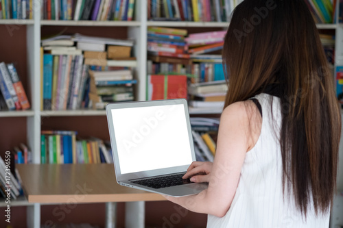 Woman using laptop in library