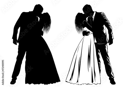 Silhouettes of kissing bride and groom