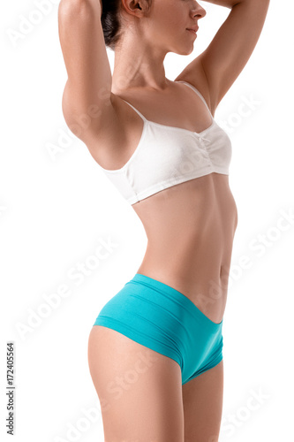 Slim tanned woman's body. Isolated over white background.