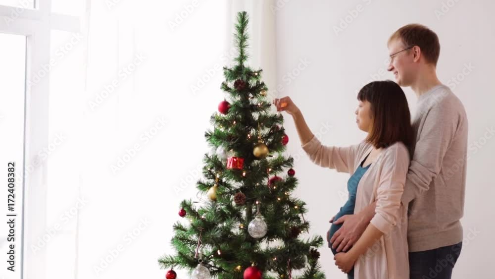 happy couple decorating christmas tree at home happy couple decorating christmas tree at home