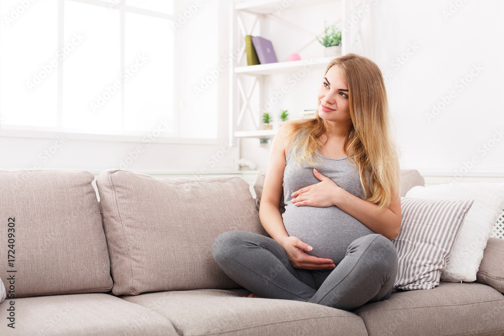 Pensive pregnant woman dreaming about child Pensive pregnant woman dreaming about child