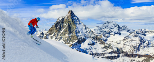 Skiing with amazing view of swiss famous mountains in beautiful winter snow. Matterhorn, Zermatt, Swiss Alps.