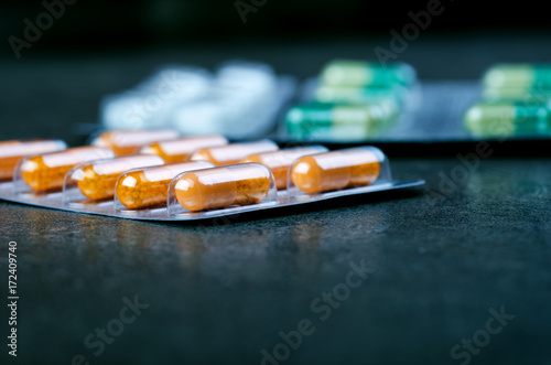 Pharmacy background on a black table. Pack of tablets on a black background. Pills. Medicine and healthy. Close up of capsules. Different kind of pills 