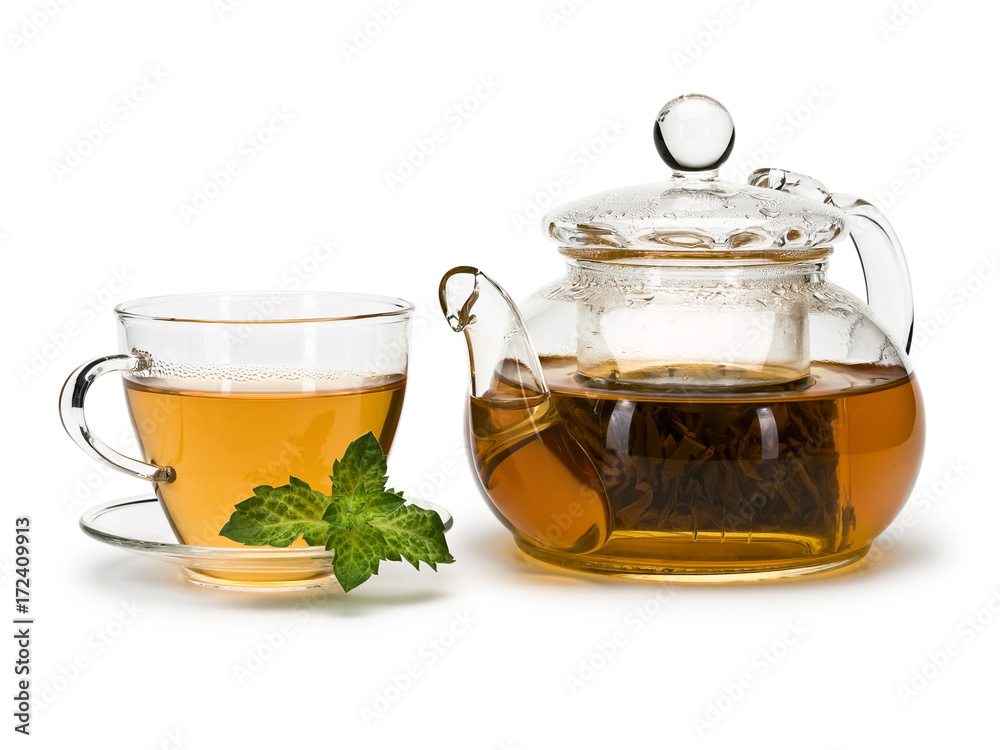 Fresh mint and green tea in a cup and a teapot from glass Fresh mint and green tea in a cup and a teapot from glass